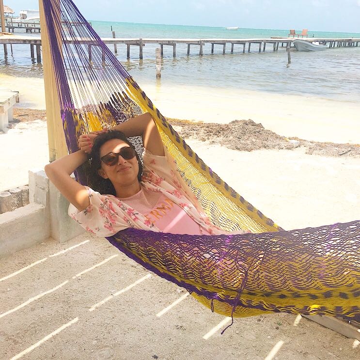 Olivia Arredondo, Account Manager at ShipEngine API, swinging on a hammock on the beach